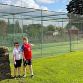 Lightcliffe junior players Dominic and Luke at the club's current nets that need to be replaced.