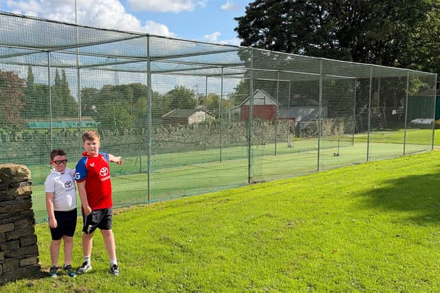 Lightcliffe junior players Dominic and Luke at the club's current nets that need to be replaced.