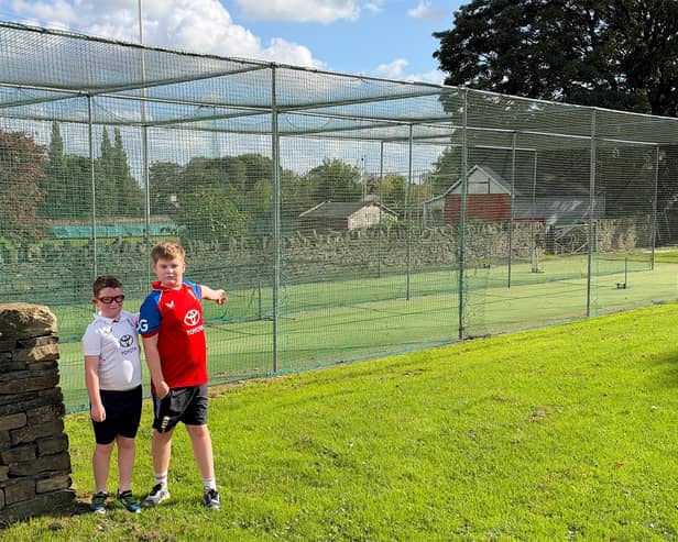 Lightcliffe junior players Dominic and Luke at the club's current nets that need to be replaced.