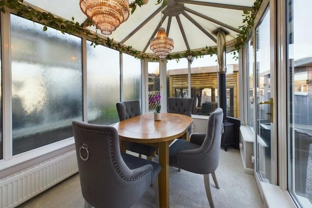 The versatile conservatory leads outside and has views of the garden.