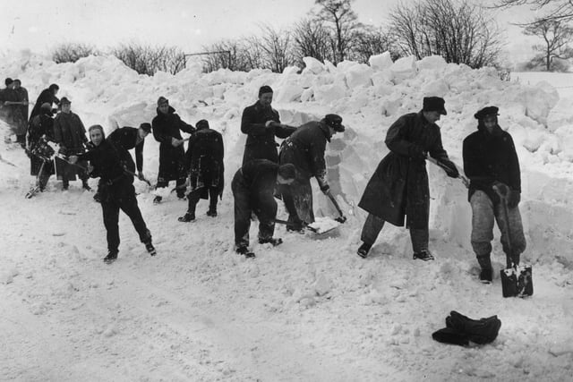 German prisoners of war are pictured clearing snow from the Whaley Bridge to Buxton road near Chapel-en-le-Frith aftrer Britain's worst blizzards for 50 years in 1947