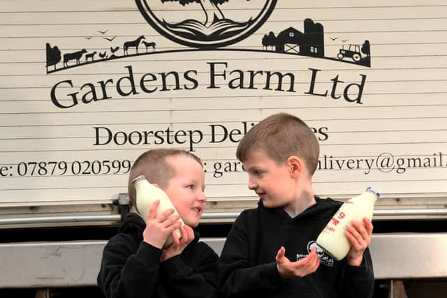George and Eric Ogden pictured with the milk at Gardens Farm Greetland