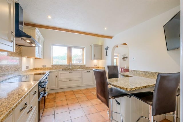 The custom made breakfast kitchen has fitted units with granite worktops, and integrated appliances.