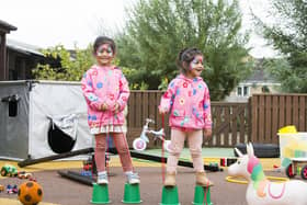 Family hub launch at the Jubilee Children's Centre in Halifax. Sisters Ayat Osama, four, left, and Amal Osama, two, have a go on stilts.