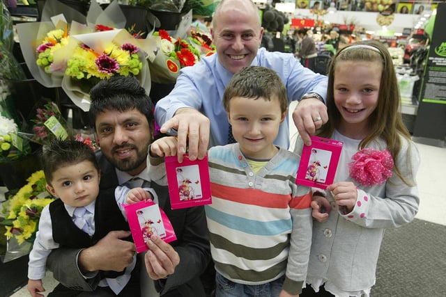 Halifax Courier Child of the Year winners given their Asda voucher prizes by Halifax Asda store manager Mark Edwards, from the left, Amar Hayat Chaudhry (Mario), one, with dad Chaudhry Umar, Jimmy Hirst, five, and Ellie Walton, nine.