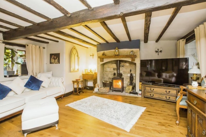 The fireplace with wood-burning stove is a focal point in t.his sitting room.