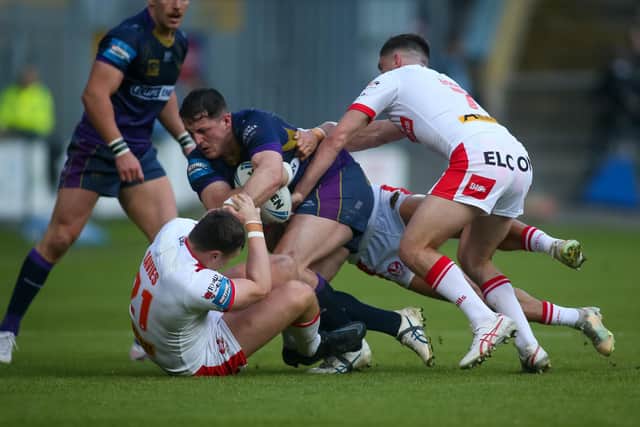 Matty Gee of Halifax is held by the Saint Helens defence during the Betfred Challenge Cup match between Halifax Panthers and St Helens at the Shay Stadium. Photo by Simon Hall.