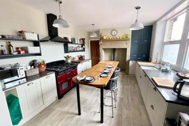 The breakfast kitchen has fitted units with granite worktops, a multi-fuel cooking range, and a fireplace with stone mantel holds a living flame gas stove.