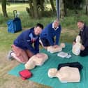 Neil Davidson (centre) with Simon Ferris, and Gary Hulme practicing CPR at the Golf Day