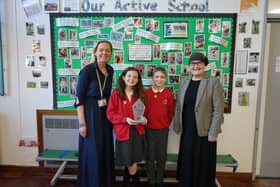 New Road Primary receiving the Diamond award (Left to right: Headteacher at New Road Primary School, Sharon Harwood; pupils at the school; and Calderdale Council’s Director of Public Health, Debs Harkins.)