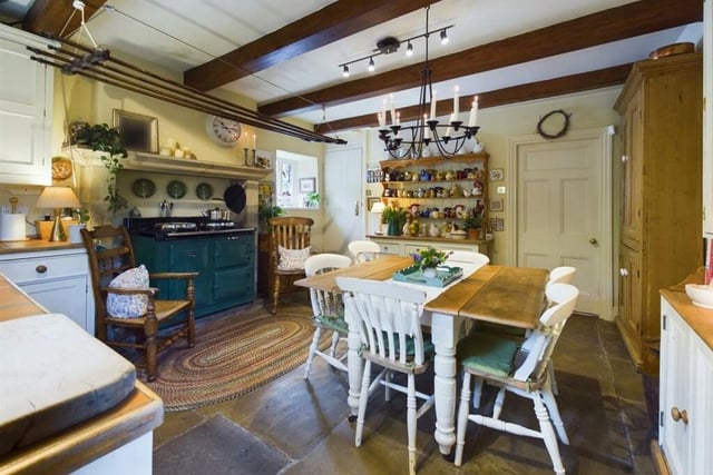 The farmhouse-style dining kitchen has an electric two-oven Aga among its appliances. There is a separate utility room.