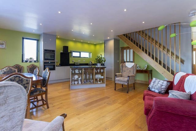 Accommodation is arranged over two floors, including a superb open-plan living room / dining kitchen with extensive bi-fold doors, a cosy sitting room, two large double bedrooms plus a single bedroom / study and two shower rooms.