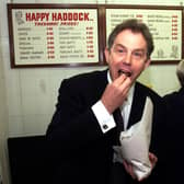 BRIGHOUSE, UNITED KINGDOM:  Prime Minister Tony Blair buys fish and chips at the Happy Haddock restaurant in Brighouse, West Yorkshire 15 May 2001, following a surprise visit to the area during his General Election campaign trail.  POOL (Photo credit should read HARRY PAGE/AFP via Getty Images)