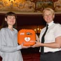 Assistant Chief Constable Catherine Hankinson of West Yorkshire Police presenting a new defibrillator to Izzy from Theatre Royal Wakefield.