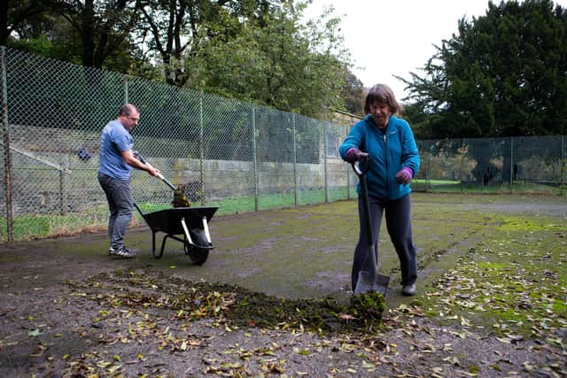 Flashback: Members of the Friends of Shelf Hall Park, pictured in 2019, clearing leaves from the tennis court at the village park in Shelf.
