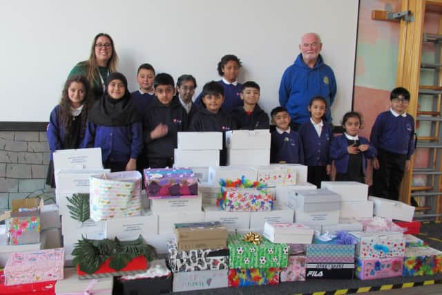 The picture was taken at a recent collection at The Halifax Academy when some 120 boxes filled by pupils and parents were collected. Rotarian Andrew Waite on the right was one of those collecting whilst the organiser of the appeal in the school, Jenni Mutch, in on the left.
