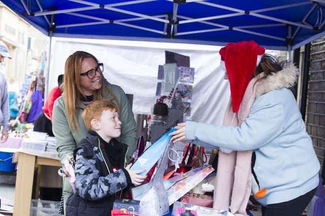 Oscar McAdam, seven, and mum Tracy McAdam win a prize on the Overgate Hospice tombola, with Luna Milthorpe, right.