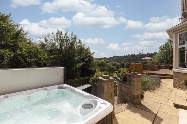 The hot tub is situated at one end of the decked terrace and enjoys far reaching views.