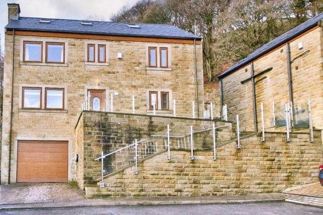 The imposing frontage of the detached stone property that has four bedrooms.