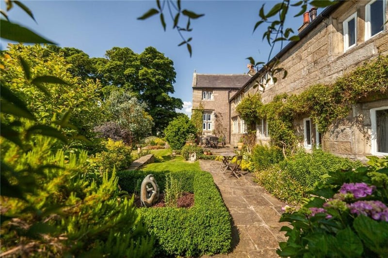 Picturesque south-facing gardens with patio areas have views across the valley.