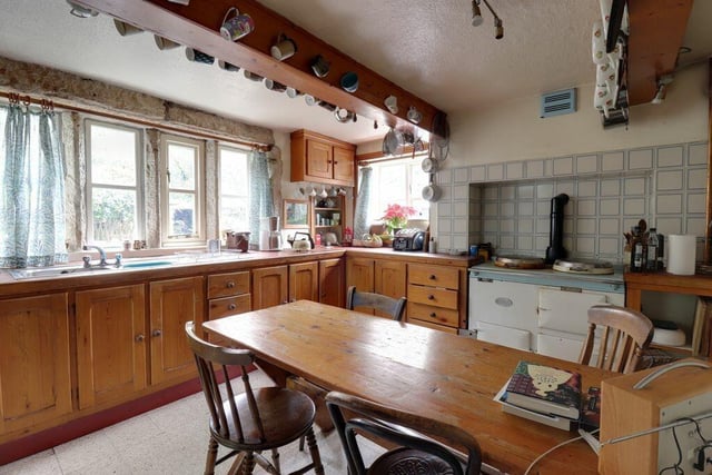 The country style kitchen with an Aga has plenty of space for a large dining table and chairs.