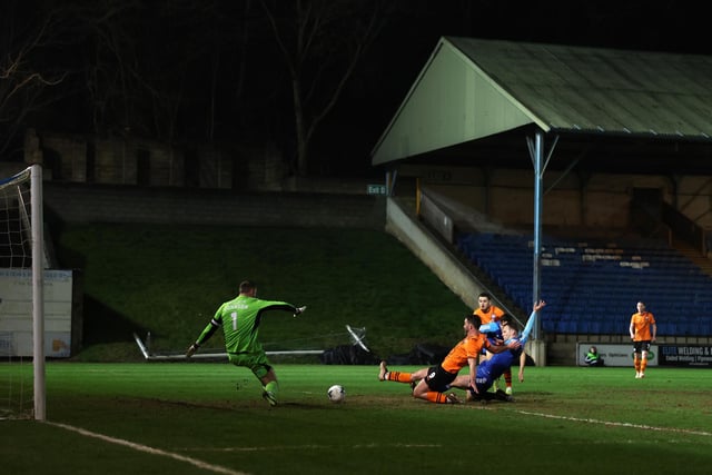 HALIFAX, ENGLAND - MARCH 20: Will Grigg of Chesterfield scores his team's first goal past Sam Johnson of FC Halifax Town during the Vanarama National League match between FC Halifax Town and Chesterfield at The Shay on March 20, 2024 in Halifax, England.  (Photo by George Wood/Getty Images)