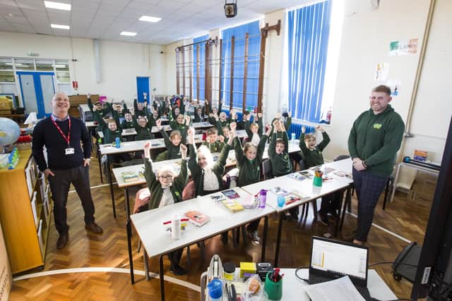 Key Stage Two children back in school at Ash Green Community Primary School upper site, with headteacher Mungo Sheppard, left, and class teacher Mr Wardman, right.