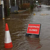 A sign reads "footpath closed". (Photo by OLI SCARFF/AFP via Getty Images)