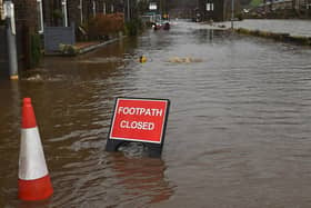 A sign reads "footpath closed". (Photo by OLI SCARFF/AFP via Getty Images)