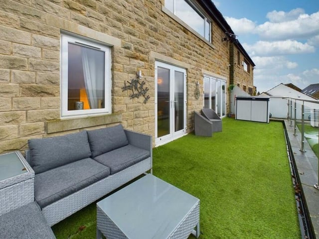 The front balcony terrace is accessed from two rooms and has far reaching valley views.