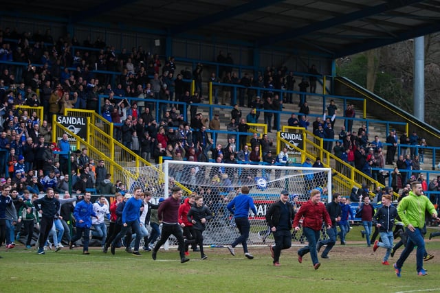 Town fans run onto the pitch after the full-time whistle