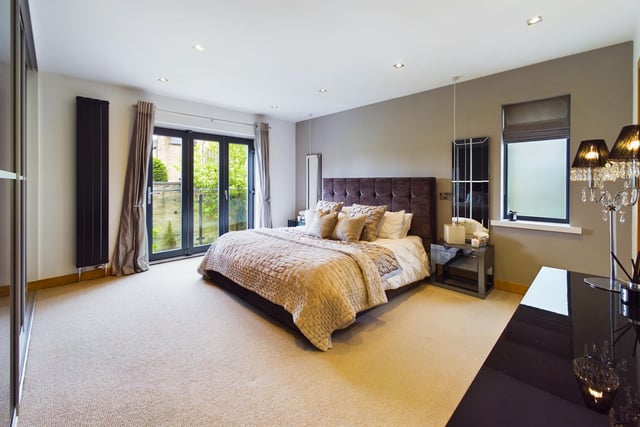 A very spacious double bedroom is one of five within the property.