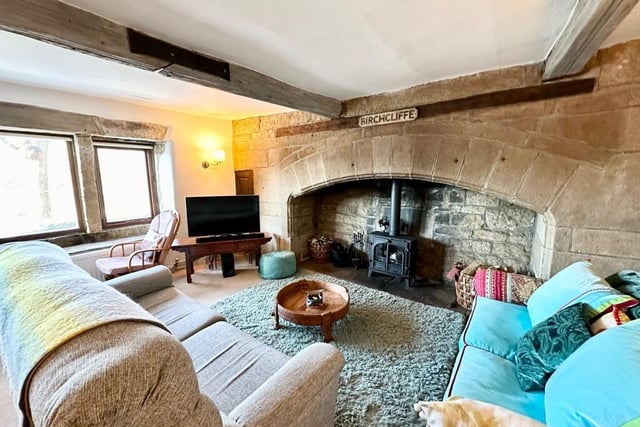 The impressive inglenook fireplace is a feature in the living area.