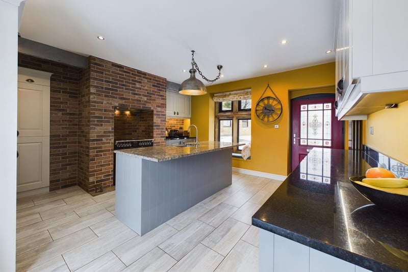 The stylish kitchen has oak units with granite worktops, and a free-standing multi-stove set in to the chimney breast.