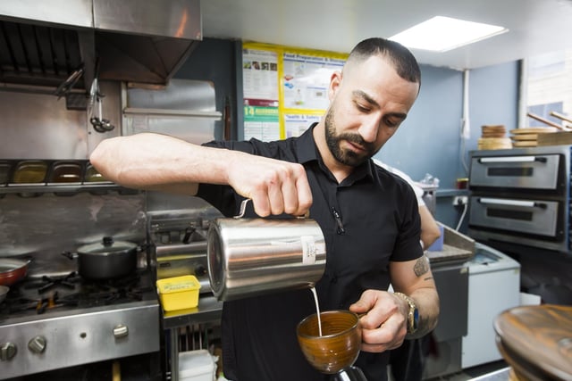 Co-owner Ozkan Peker makes a coffee.