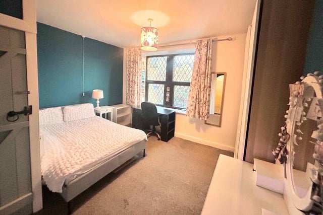 A spacious double bedroom is one of five bedrooms.