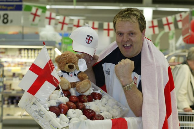 Supporting the England football team, Gary Webb, 46, is pictured in the fruit and vegetable aisle at ASDA