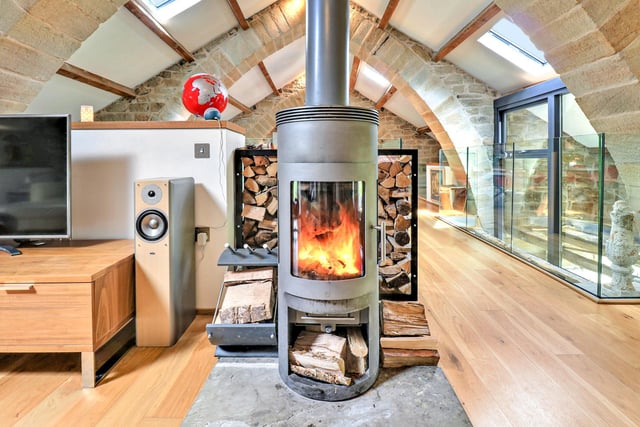 The warming woodburner stove in the end lounge area within the property.