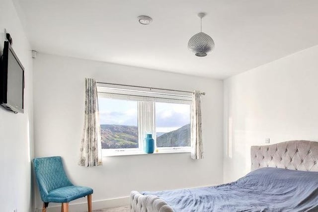 A double bedroom with a stunning view from its window.