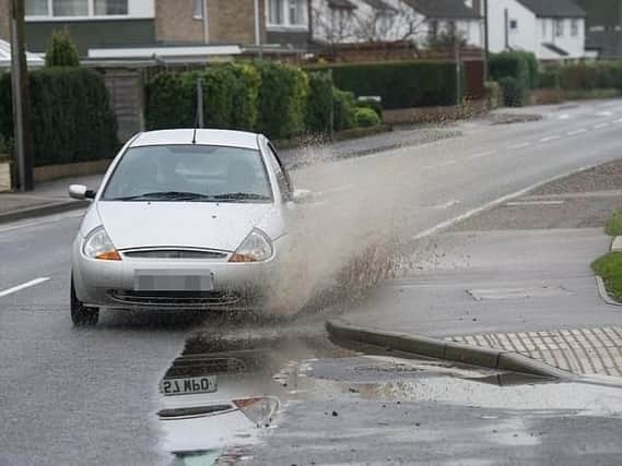 Car drives through a puddle