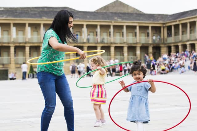 Arissa Qureshi, one, and mum Nayer Qureshi try hula hooping at the Sunday street festival.