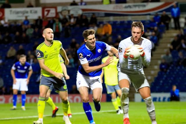 Halifax keeper Sam Johnson holds onto the ball under pressure very late in the game. Chesterfield 2-3 FC Halifax Town. Picture: John Hobson/AHPIX LTD.