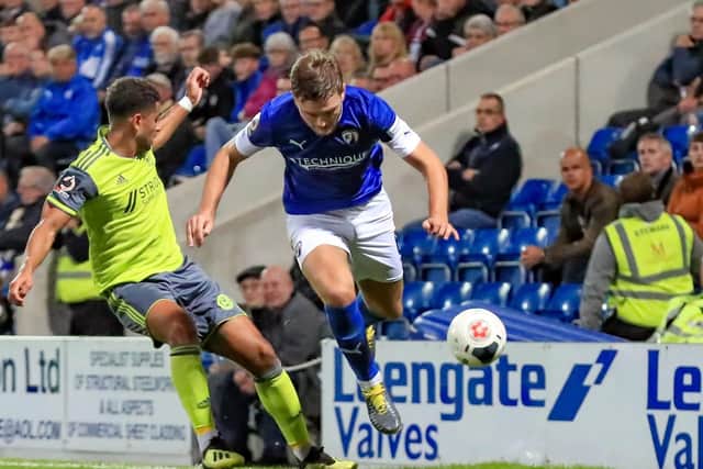 Chesterfield's Laurence Maguire jumps a tackle from Town's Jamie Allen. Chesterfield 2-3 FC Halifax Town. Picture: John Hobson/AHPIX LTD.