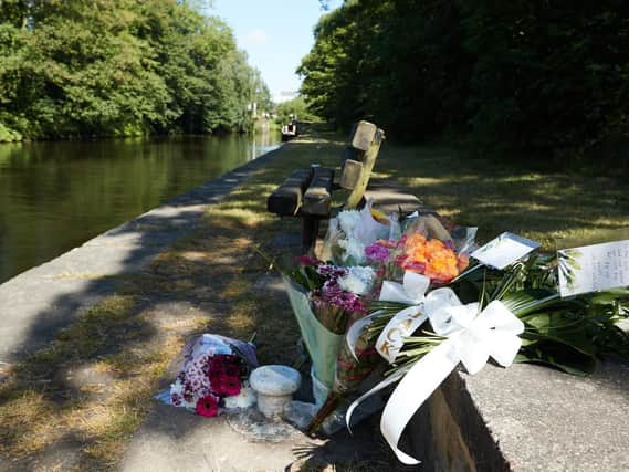 Tributes on the canal at Cooper Bridge