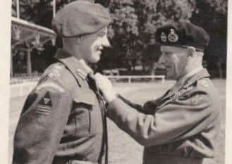 General Sir Robert Bray receiving a Distinguished Service Order from Field Marshal Montgomery, who signed the photo, in France in 1944