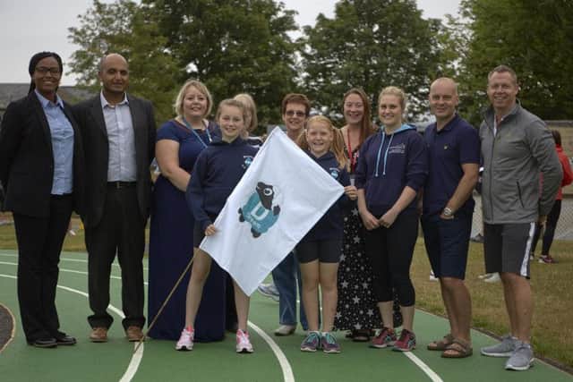 Representatives from National Grid, School staff, governors pupils unveil the running track