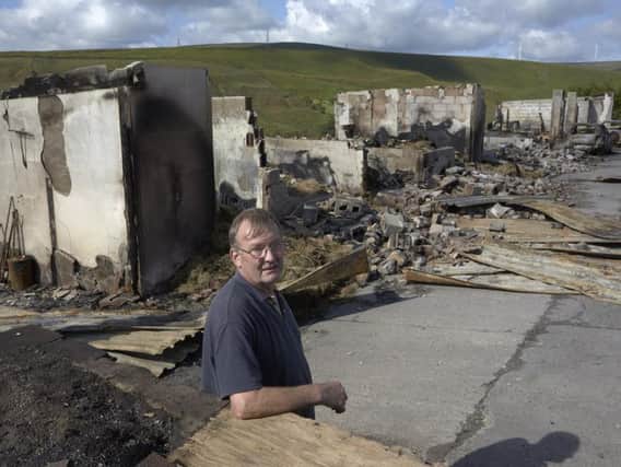 Peter Lobb overlooks the damage caused by the fire at Cyprus Farm, Todmorden.