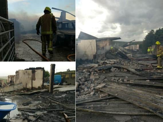 Firefighters clean up after the blaze at the Todmorden fire