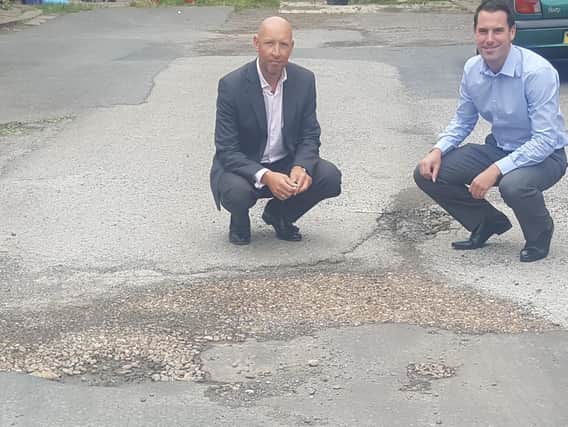 Councillors Scott Benton and Howard Blagbrough at a potholed Birds Royd Lane