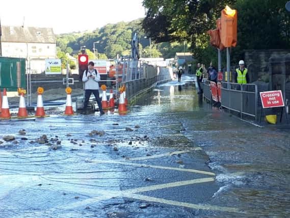 Water main burst and the Mythomroyd flood alleviation work taking place in the background (Calderdale Council)